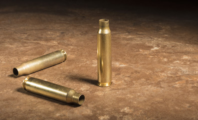 Fototapeta premium Trio of empty AR-15 cartridges on the floor