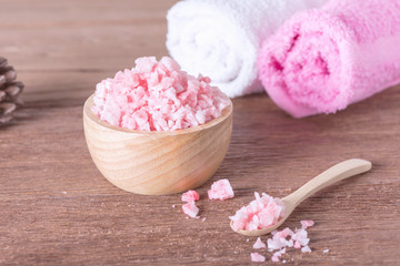 Pink spa salt in wooden bowl with orchid flower and towel. For this photo applied color tone effect.