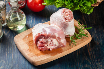 Raw turkey knuckle on cutting board ready for baking.