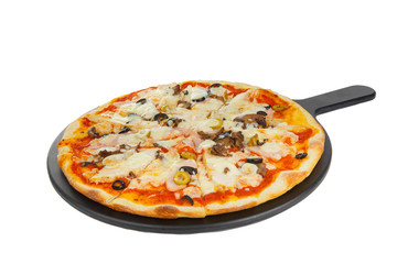 Pizza whole round on a black tray, blackboard, cut into pieces, on a white isolated background. Fast food in a pizzeria, a floury cheese product. Side view
