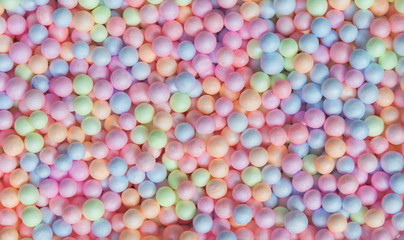 Fototapeta na wymiar Abstract background from colorful small foam balls patter in box. Happy holiday and travel background concept. Picture for add text message. Backdrop for design art work.