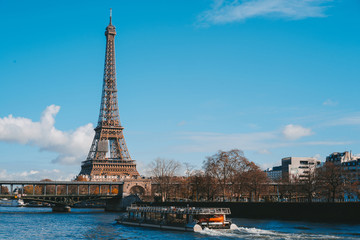 view on Eiffel Tower and boat on river in Paris, France