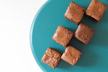  Delicious sweets from chocolate on bright dishes on a white background.