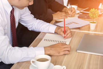 Obraz na płótnie Canvas Male employee writing business plan at workplace