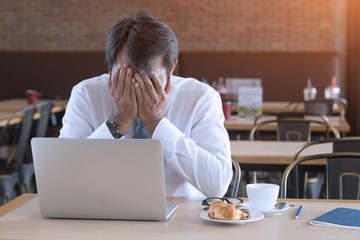 Asian businessman frustrated on his work and out of control.