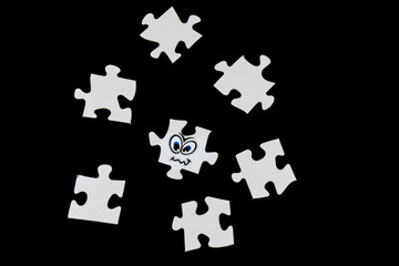 Puzzle pieces with a funny face, black background