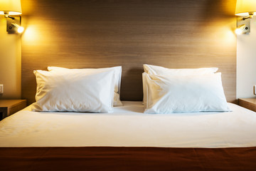 pillows on the large double bed. The concept of preparing a bed in a hotel room or at home. Modern interior
