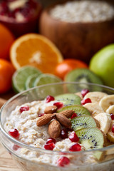 Breakfast still life with oatmeal porridge and fruits, top view, selective focus, shallow depth of field.