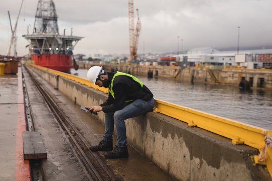 Dock worker using mobile phone