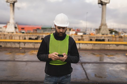 Dock worker using mobile phone