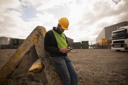 Dock worker using mobile phone