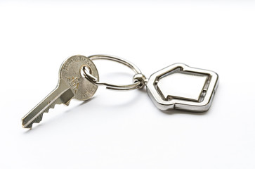 House key on a keyring with house design, on a white background.