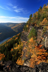 river in between an autumn mountain