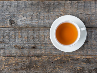 White tea Cup and saucer on a rustic wooden background Copy space