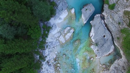 AERIAL top down view: flight over mountain river Soca. Camera flying forwards