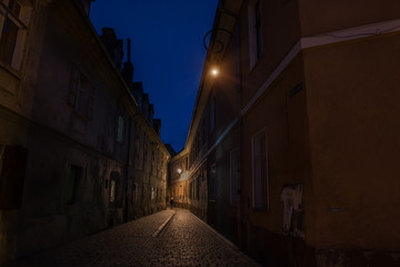 Narrow ancient street of the old city. night photo. Brasov. Romania. Europe.
