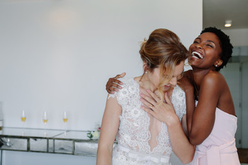 Fototapeta na wymiar Bride and bridesmaid on the wedding day in hotel room