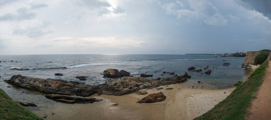 Fototapeta na wymiar Landscape view on rocky coast ocean in Galle Srilanka in cloudy weather
