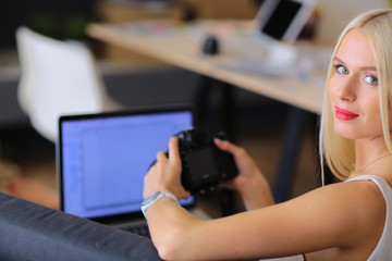 Young photographer and graphic designer at work