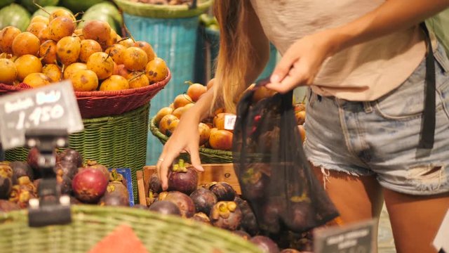 Young Mixed Race Woman Shopping without Plastic Bags in Grocery Store. Vegan Zero Waste Girl Choosing Fresh Exotic Fruits in Supermarket. 4K.