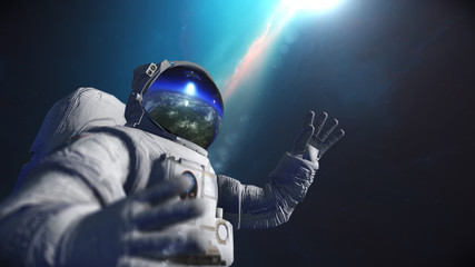 Astronaut in outer space against the backdrop of the planet earth. Elements of this image furnished...