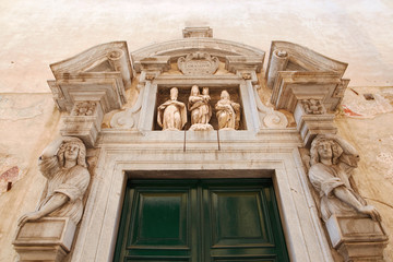Bergamo, Italy - August 18, 2017: The front door of an old house.