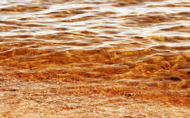 Beautiful gold waters with soft rippling surface 
