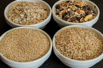Quinoa, brown rice and oats. Healthy whole grain cereals. Vegan food concept. Wholemeal carbohydrates