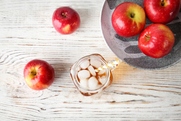 Composition with fresh apple juice on wooden table, top view