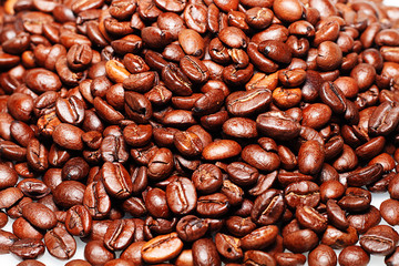 Grains of roasted coffee on a white background