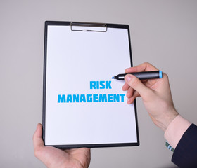 A businessman shows an inscription:RISK MANAGEMENT