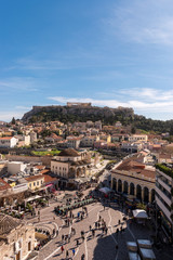 View of Acropolis rock and Monastiraki square at Athens on blue sky background.
