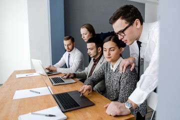 Group of businessmen working with a laptop