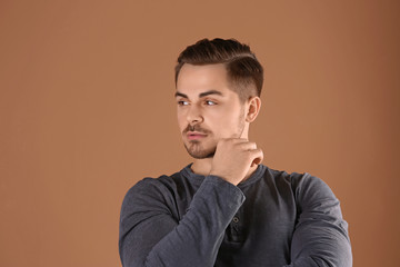 Fototapeta premium Portrait of young man with beautiful hair on color background