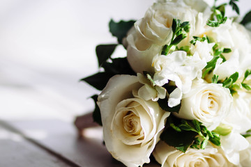 Wedding bouquet of white roses. The soft and light flowers .