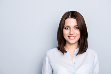 Obraz premium Portrait with copy space, empty place of cheerful, modern, nice girl with short hair, isolated on grey background, looking at camera