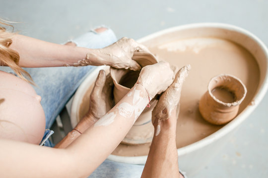 Artisans make close-up works of art in the pottery workshop molding a ceramic vase
