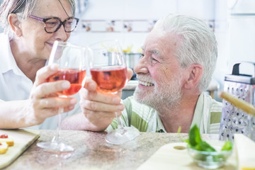 senior couple drinking wine at home