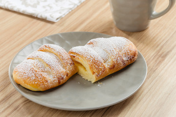 Fresh baked puff bun with custard on gray plate