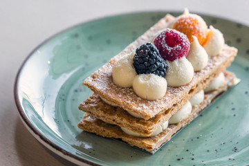 Beautifully decorated cream slice on plate at a bakery shop in Minsk, Belarus.