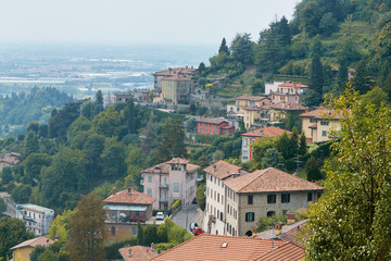 Fototapeta na wymiar Bergamo, Italy - August 18, 2017: Panoramic view of the city of Bergamo from the castle walls