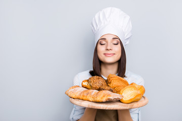 Seller customer palatable gourmet service industry people professional rack concept. Close up portrait of delightful  peaceful lady smelling appetizing freshly baked products isolated gray background