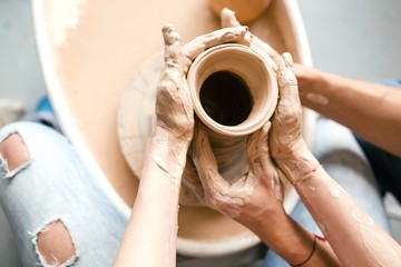 Fototapeta na wymiar Hands together ceramics make a girl pregnant with a man close up