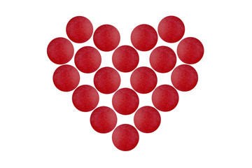 Red tablets in shape of heart isolated on white background. 