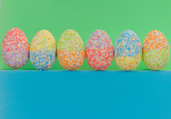multicolor decorated easter eggs sorted on colorful background 