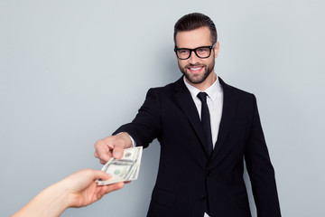 Portrait of cheerful excited smart confident focused salesman agent entrepreneur freelancer in white shirt necktie black blazer taking money from costomer's hand isolated gray background copy-space