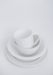 white utensils three plates cup white background vertical frame isolated