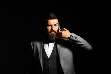 Macho in formal suit has his beard and moustache cut.