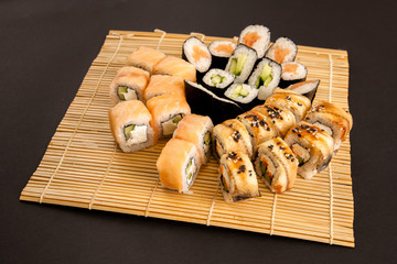 Set - sushi, rolls, sashimi on the mat