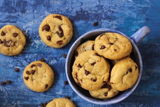 Homemade Chocolate Chip Cookies On Dark Blue Background, Overhead View